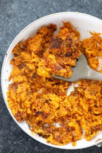 sweet potato fries in a pan with a fork, transformed into sweet potato hash browns.