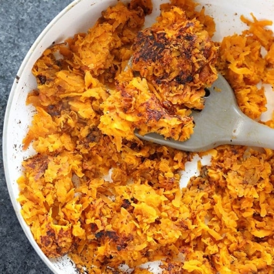 sweet potato fries in a pan with a fork, transformed into sweet potato hash browns.