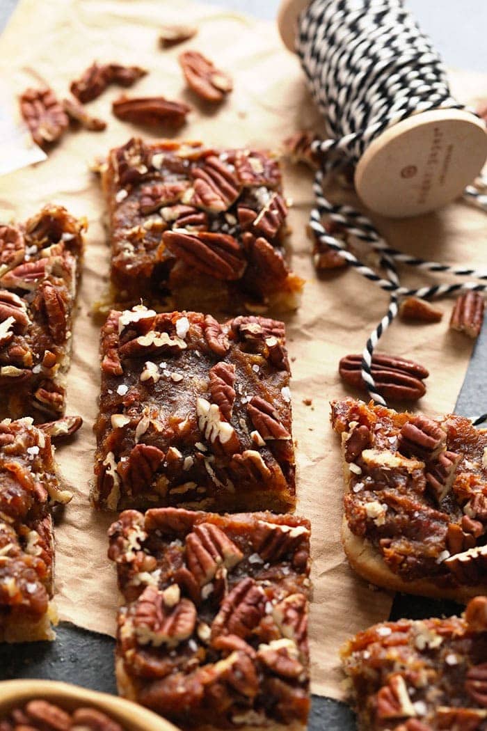 These easy pecan pie bars are a healthy dessert that the whole family will love! They are made with date caramel, pecans, and a delicious almond shortbread crust. This is not your typical granny pecan pie recipe. Make them today! Finished pecan pie bars
