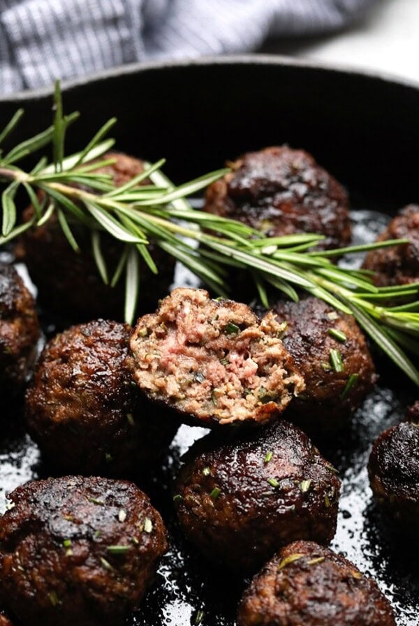 Easy meatball recipe made in a skillet with rosemary sprigs.