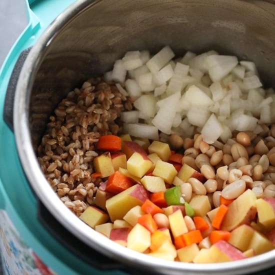 A slow cooker filled with leftover turkey soup.