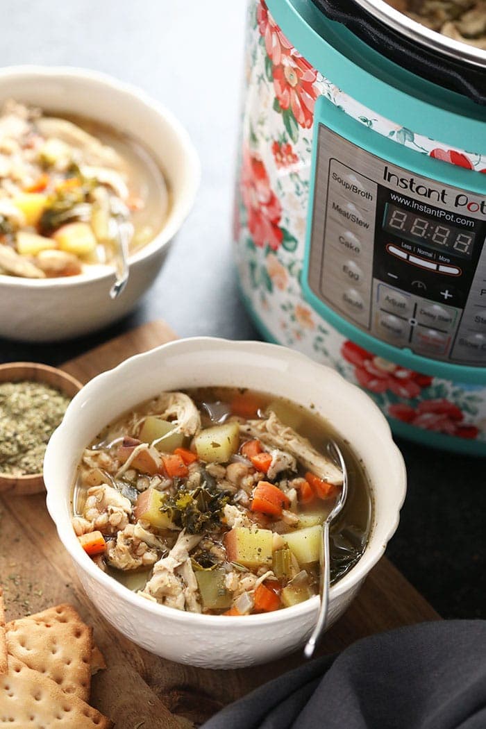 Tuscan Turkey Soup in bowl next to Instant Pot