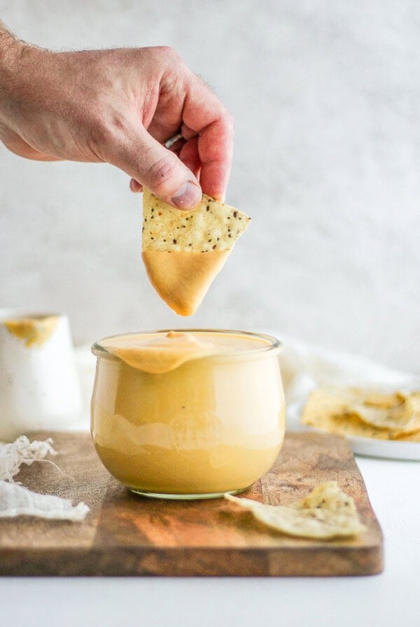 cheese sauce in jar with chip.