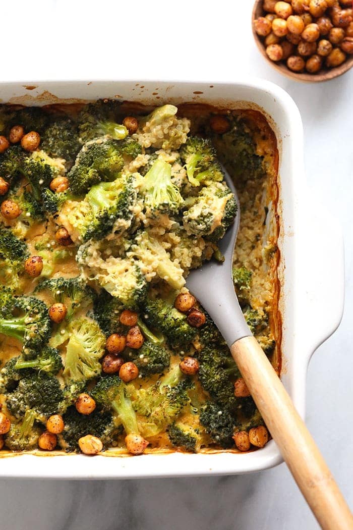 healthy vegan broccoli and cheese casserole being scooped with a spoon