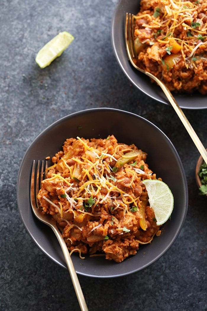 A bowl of slow cooker chicken enchilada casserole.