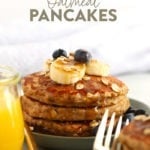 Banana oatmeal pancakes topped with blueberries and served on a plate.