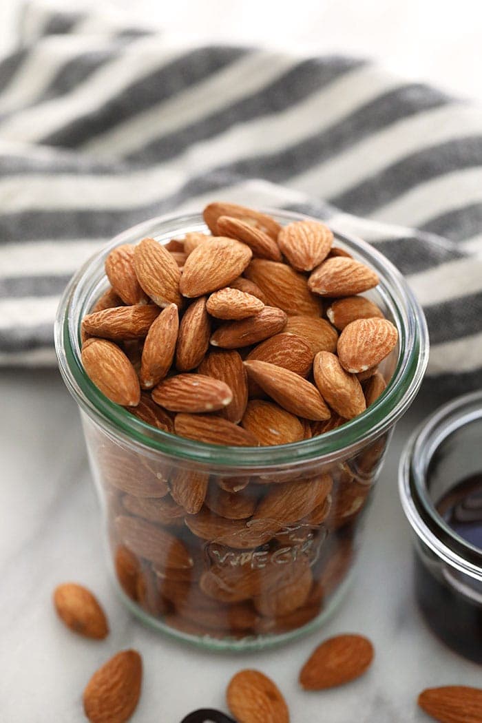 almonds in a jar ready to be roasted for almond butter.