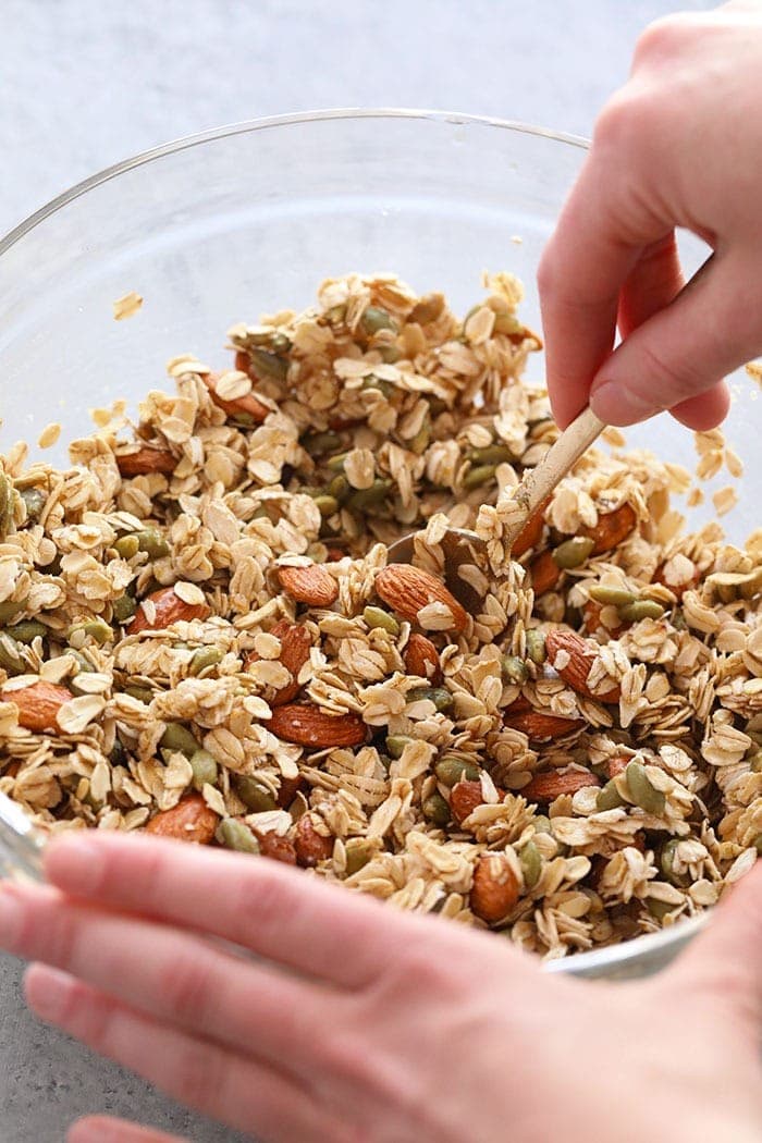 Mixing all the ingredients for healthy granola in a bowls.