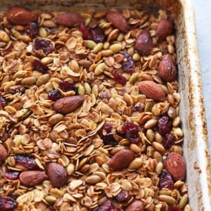 Healthy granola with nuts and cranberries in a baking pan.