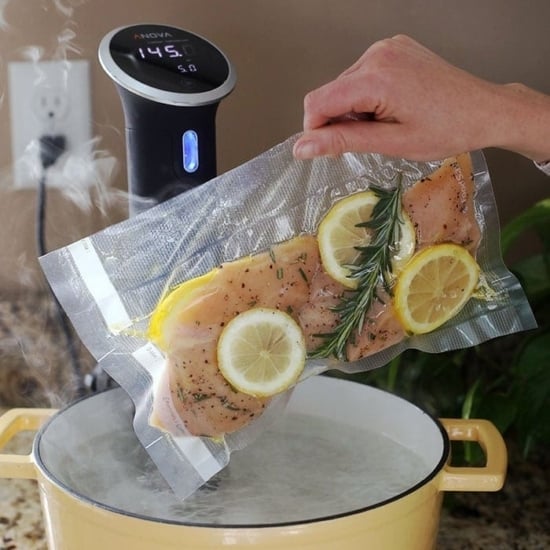 sous vide chicken breast going into pot of water.