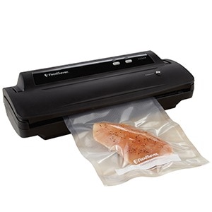 A vacuum sealer with sous vide chicken breast in it.