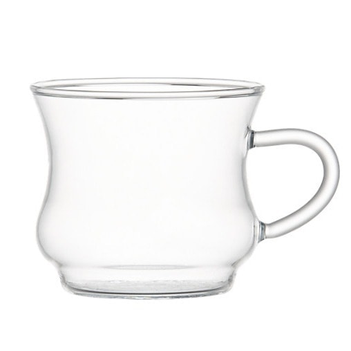 a clear glass cup with a handle holding a chai tea latte on a white background.