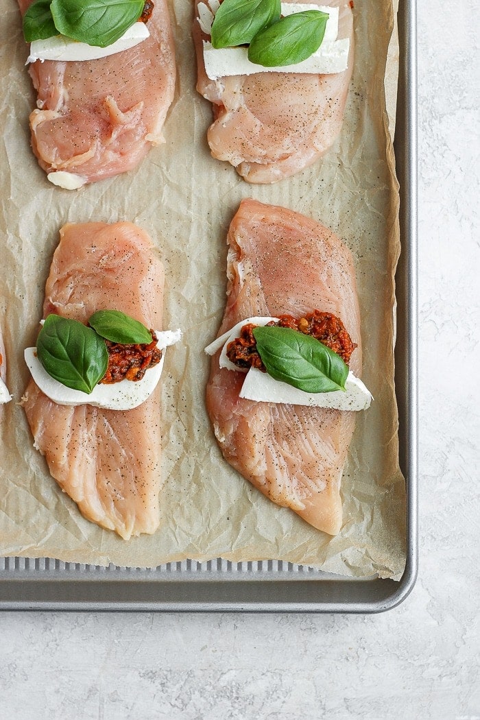 Caprese stuffed chicken breast on a baking tray