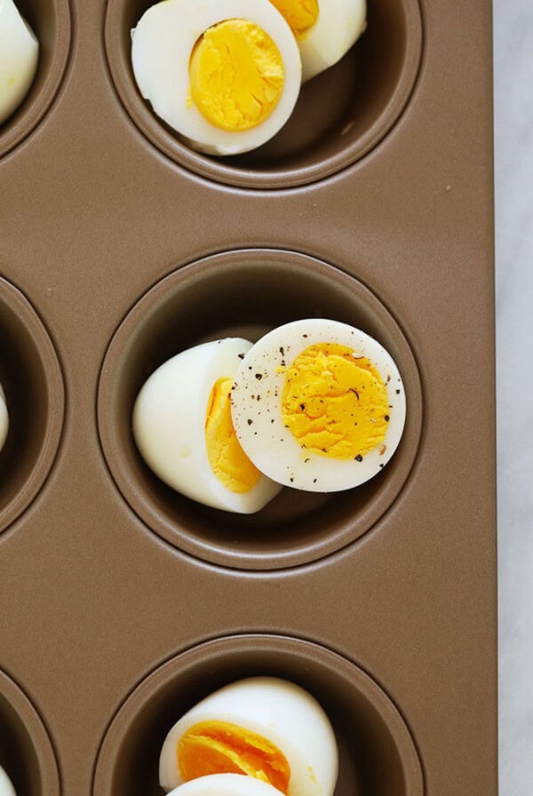 Hard boiled eggs cooked in an oven using a muffin tin.