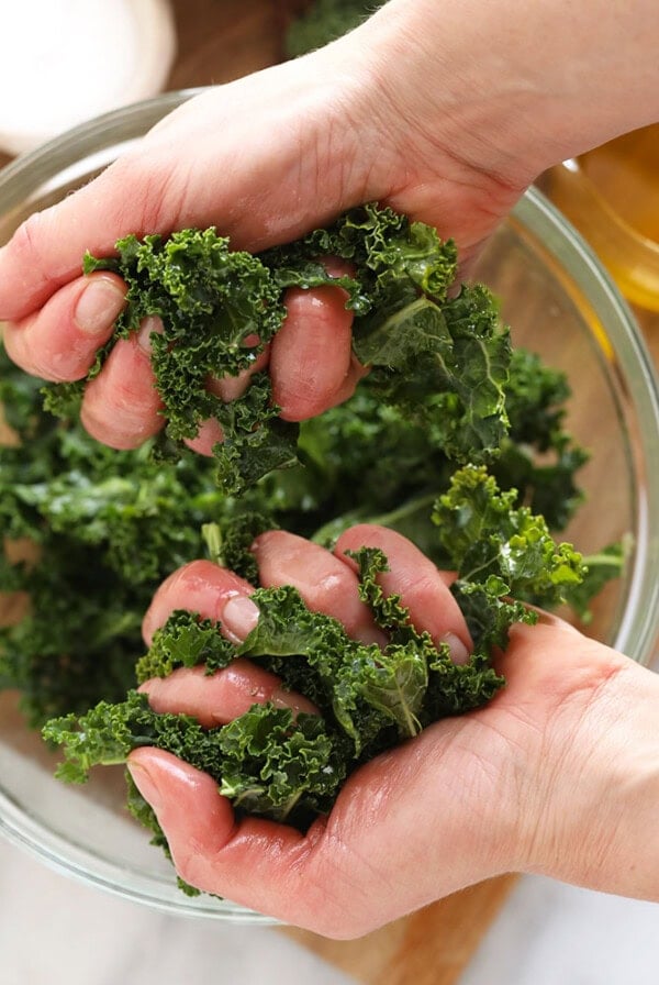 A step-by-step guide on how to massage kale using your hands.