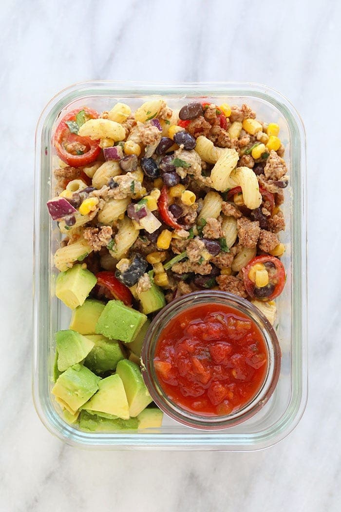 Meal Prep Container with taco pasta salad, avocado, and salsa.