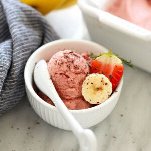 a bowl of banana nice cream with strawberries.
