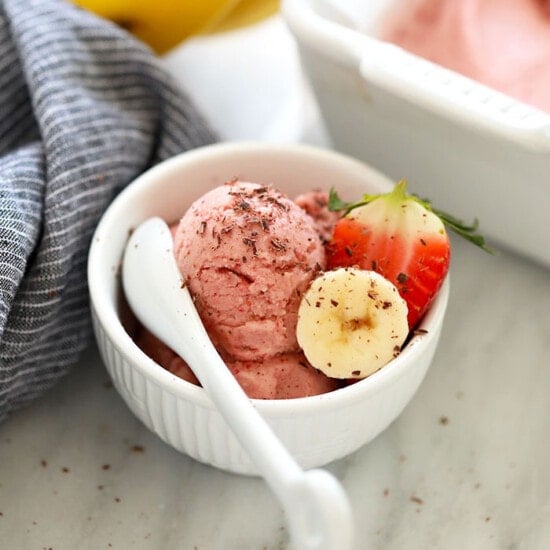 a bowl of banana nice cream with strawberries.
