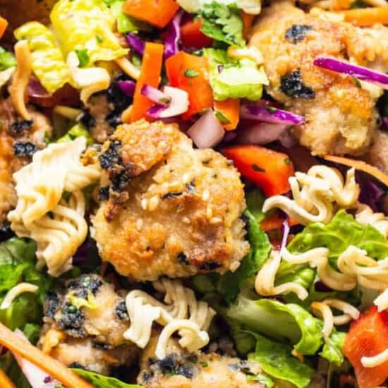 An Asian-inspired chicken noodle salad in a bowl.
