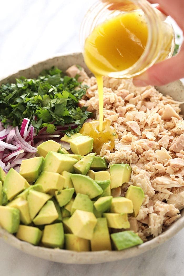 Avocado tuna salad ingredients in a bowl.