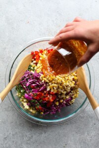 mixing corn salad in bowl.