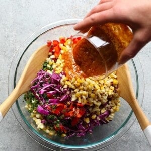 mixing corn salad in bowl.