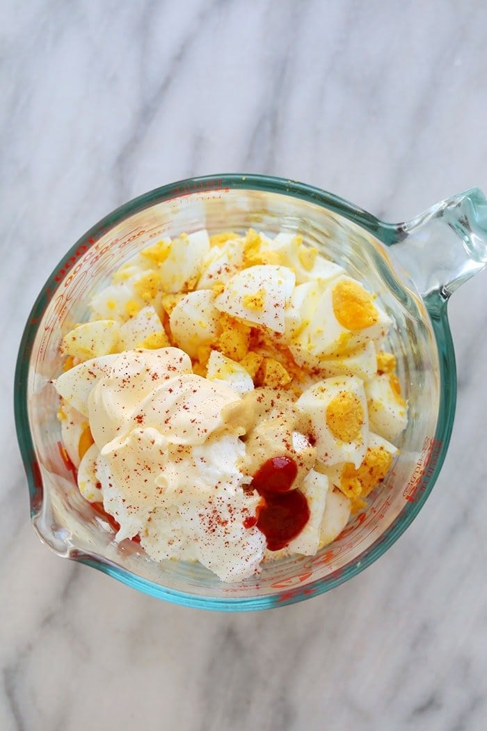 Healthy egg salad ingredients in a bowl.