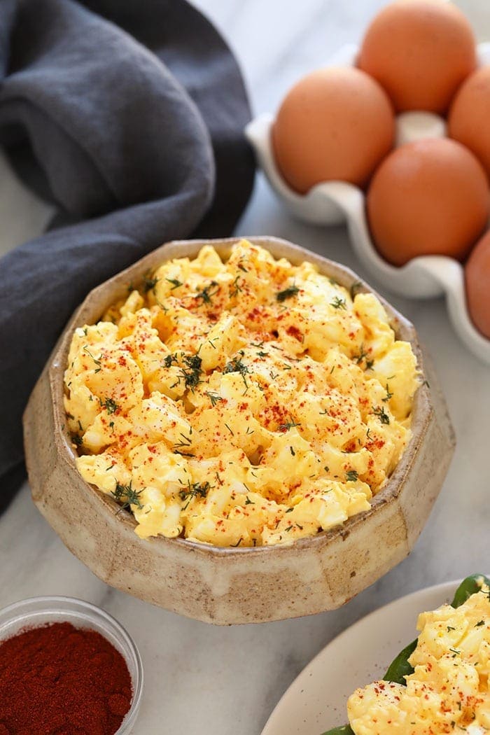 Healthy egg salad in a bowl topped with dill.