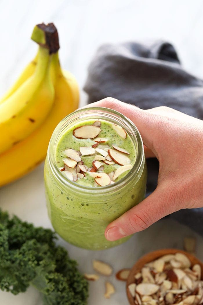 kale smoothie topped with slivered almonds