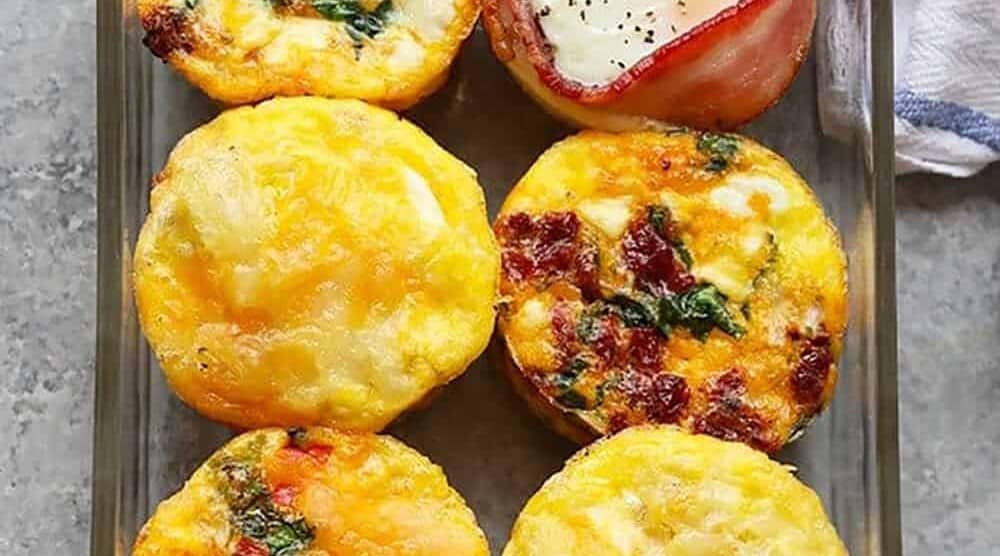 Breakfast egg cups baked in a glass dish.