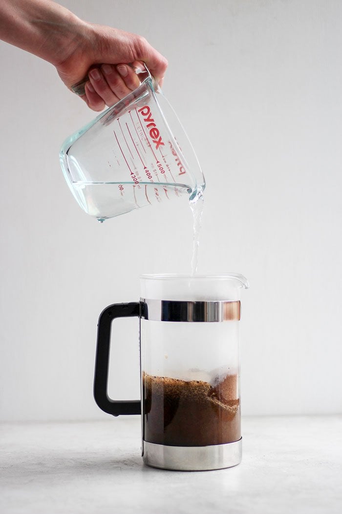 Pouring hot water into a French press. 