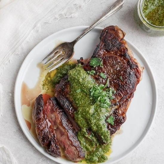sous vide steak on plate with green sauce.