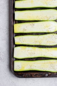 sliced zucchini on baking sheet.
