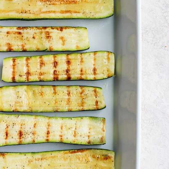 Grilled zucchini on a baking sheet.