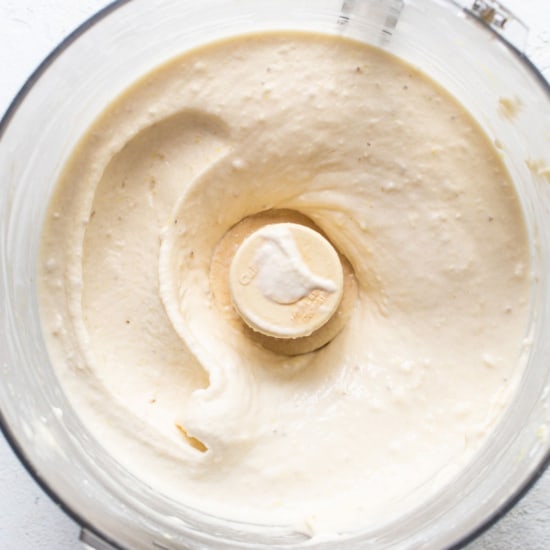 Banana nice cream being mixed smoothly in a food processor.