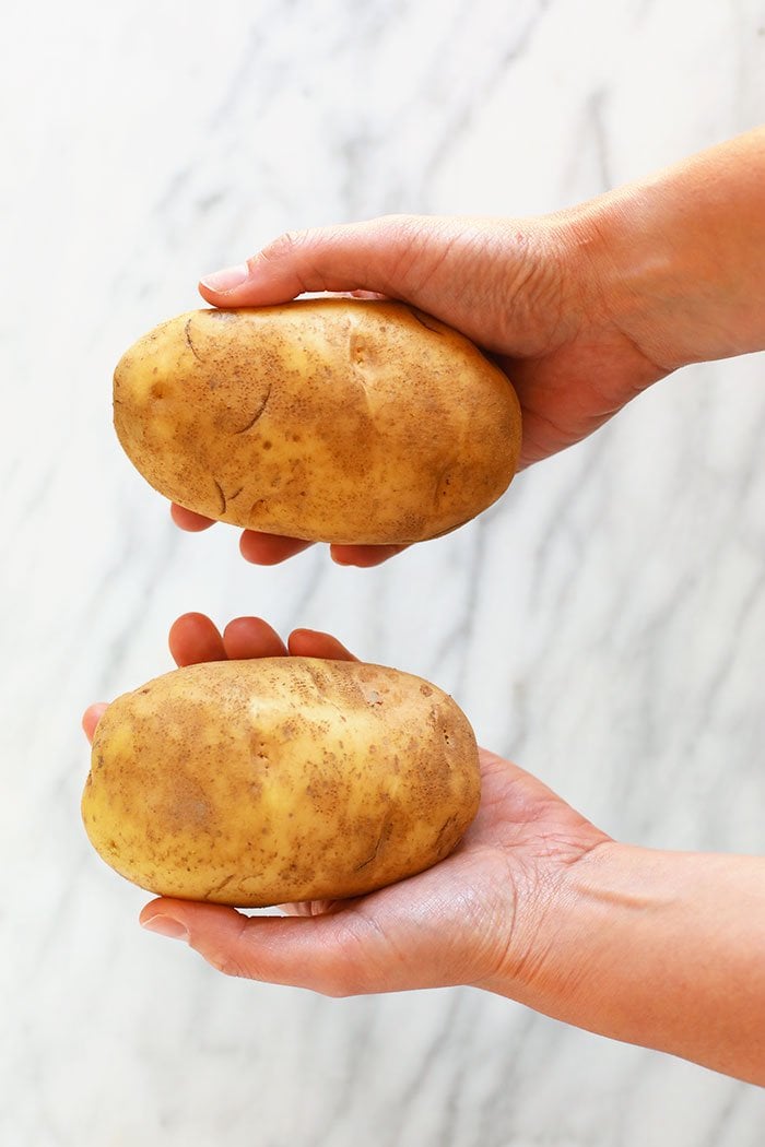 hands holding poatoes