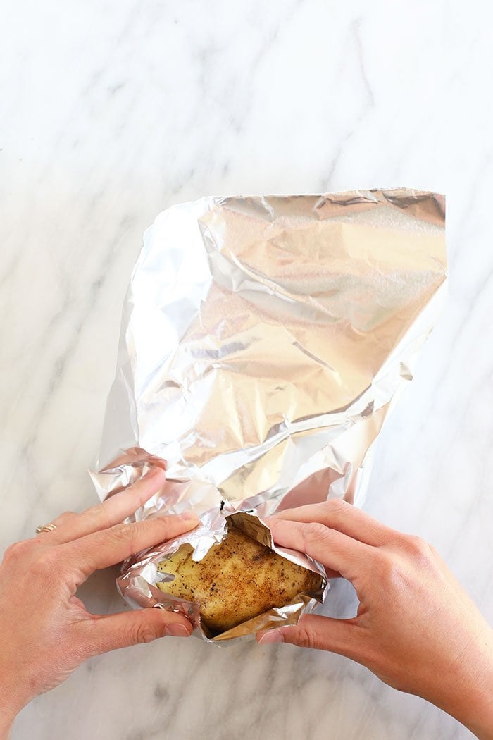 rolling potatoes in foil