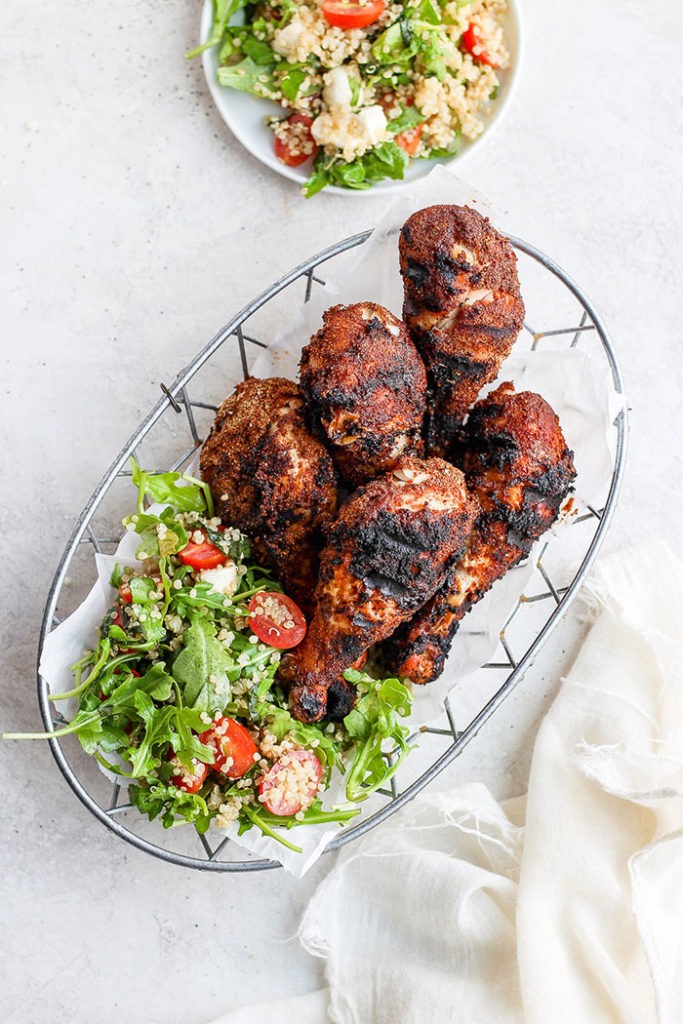 grilled chicken drumsticks in basket.