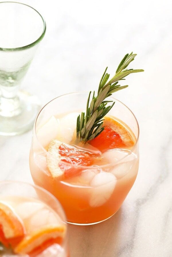 A Greyhound cocktail meets a grapefruit margarita, garnished with rosemary sprigs.