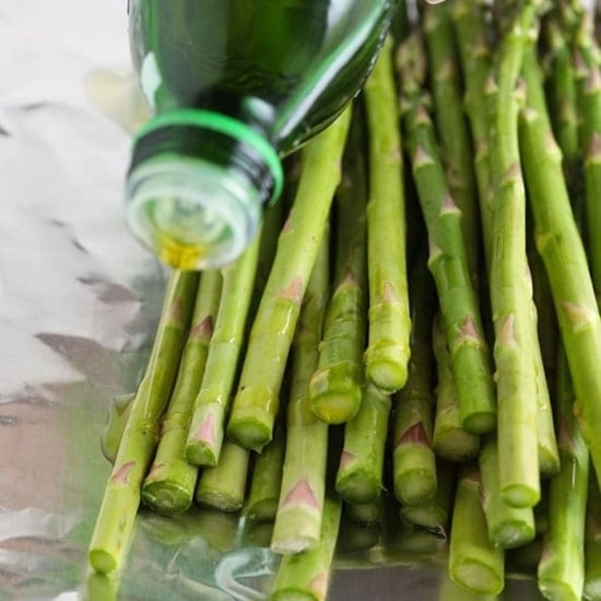 drizzling olive oil on asparagus.