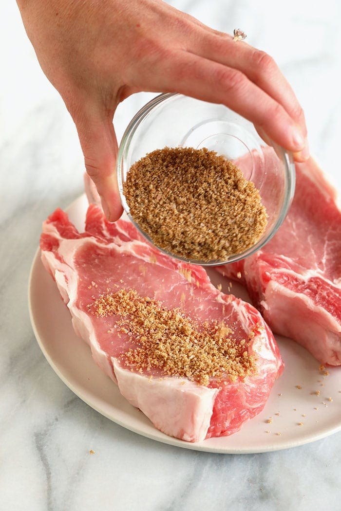 pouring spices on pork