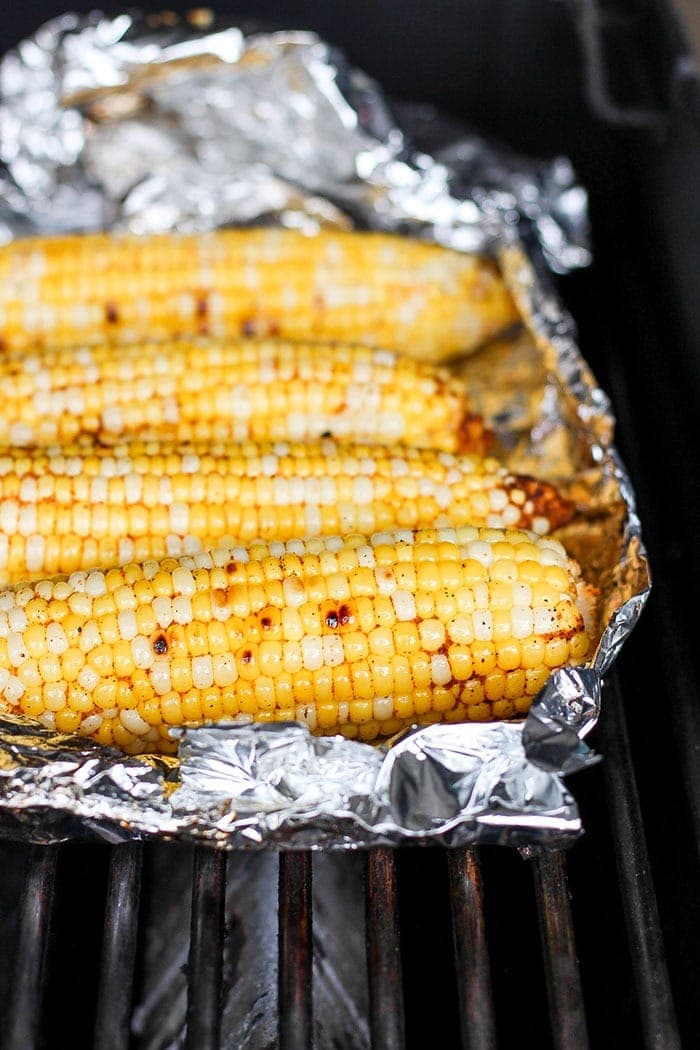 corn in tin foil on grill.