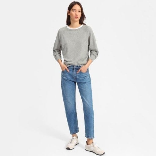 A model is wearing a size S Everlane sweatshirt in grey.