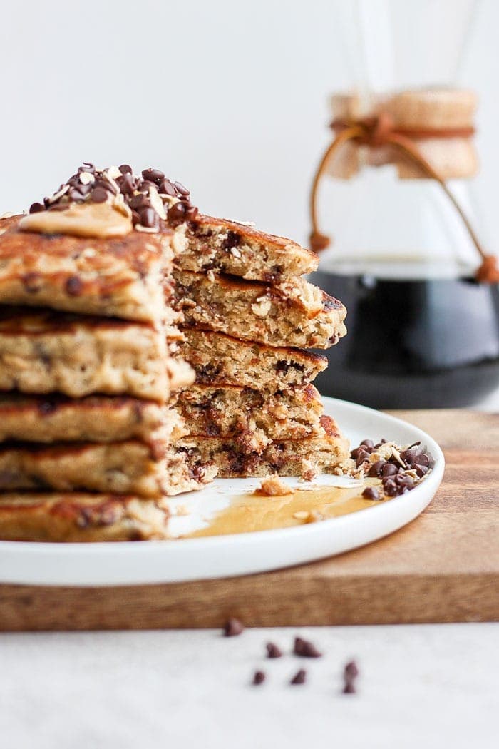 stack of pancakes sliced with maple syrup