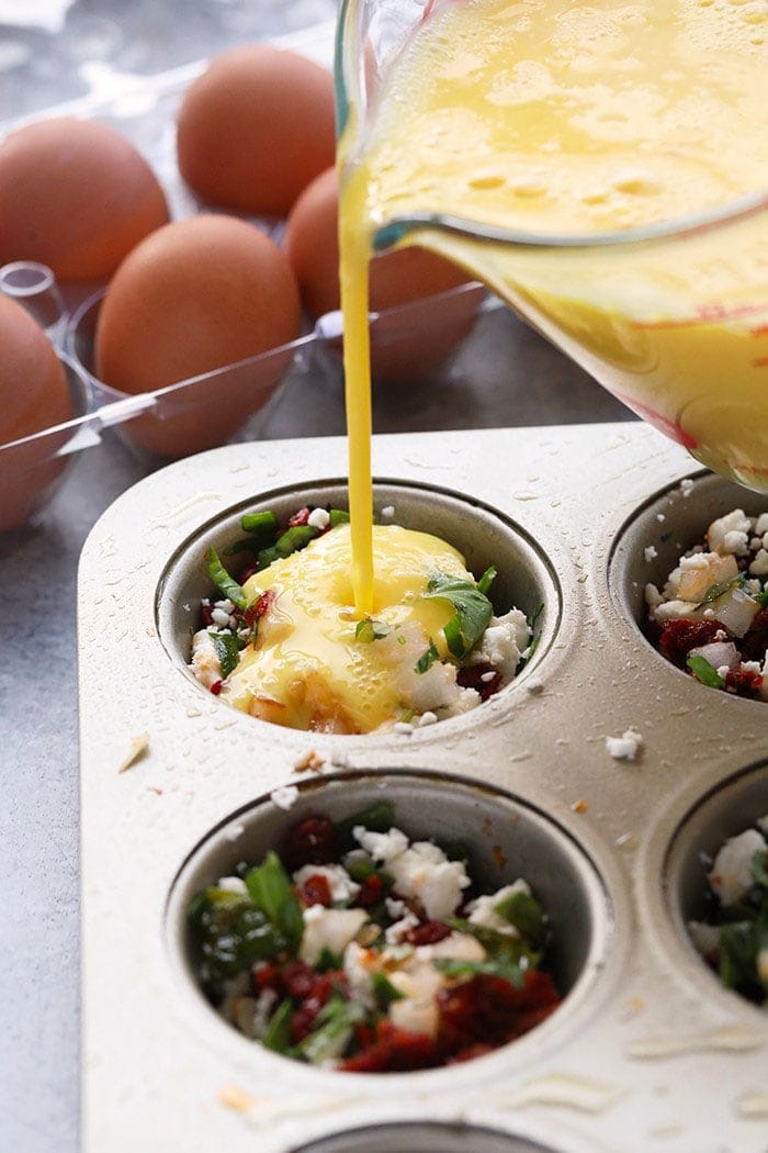 pouring eggs into muffin tin