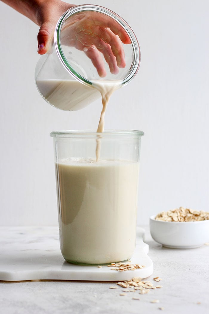 Pouring oat milk into a glass