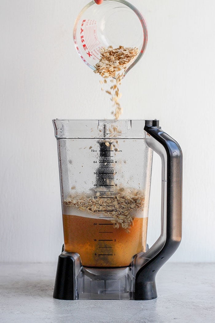 Pouring oats into a blender