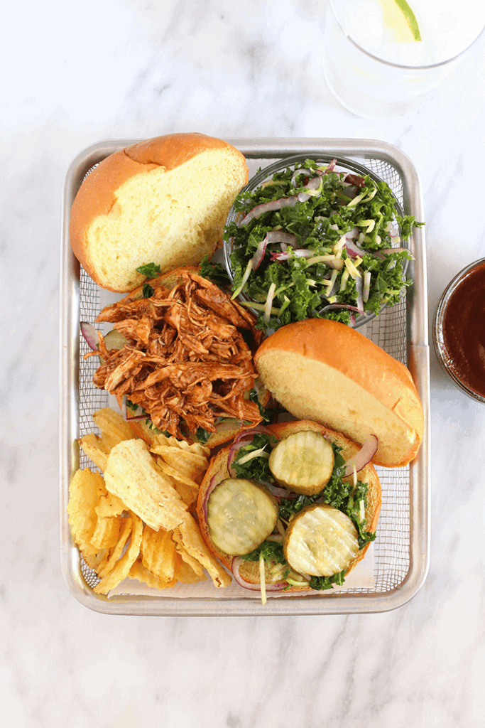 slow cooker bbq pulled chicken in basket with chips and slaw