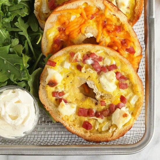 a tray of bagels with bacon and cheese