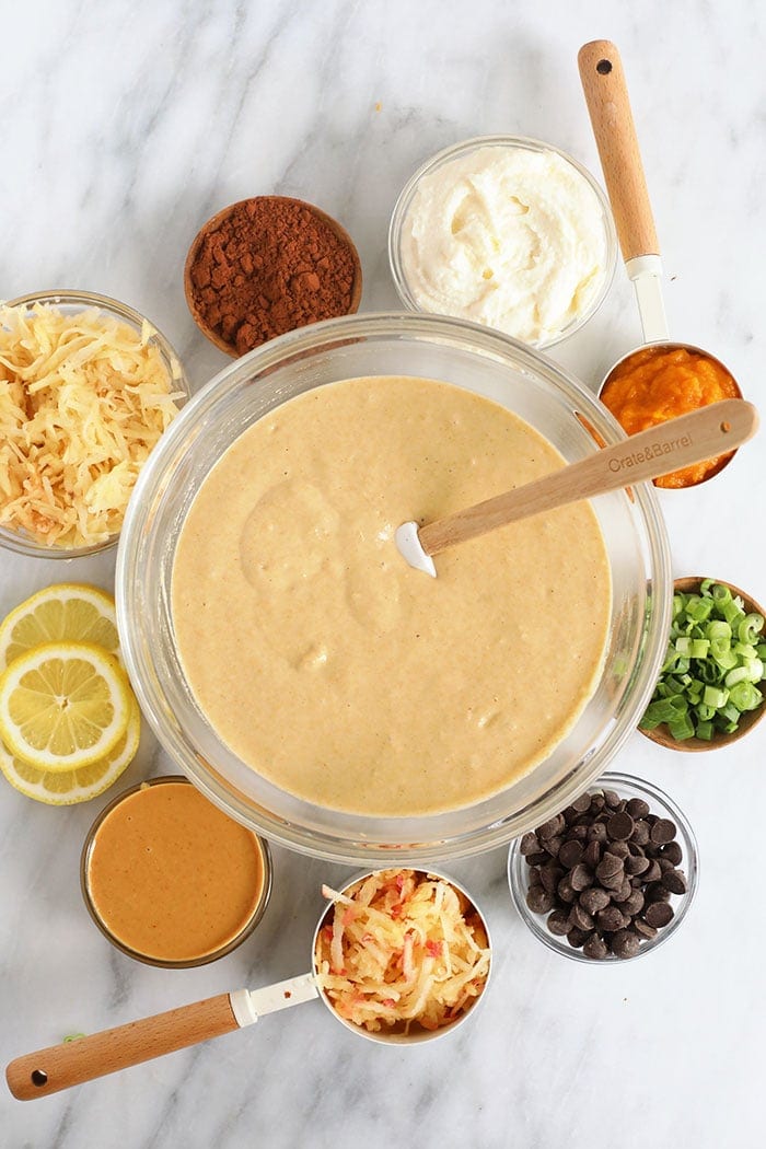 Pancake batter in a bowl with ingredients surrounding it